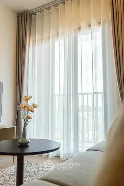 Elegant living room with sheer curtains and cozy decor