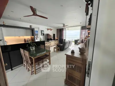 Spacious living room with modern decor and stunning ocean view, perfect for relaxation and entertainment.