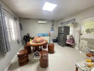 Spacious kitchen with modern appliances and wooden dining set in a cozy home.