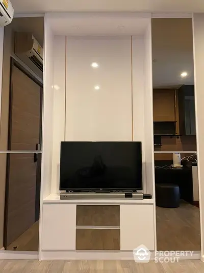 Modern living room with sleek TV unit and air conditioning