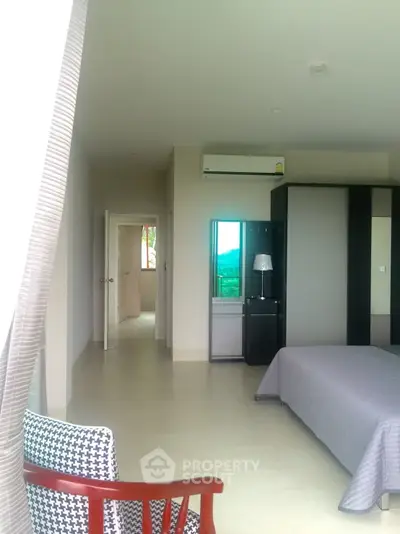 Spacious bedroom with modern amenities, large bed, and a serene view, featuring an en-suite bathroom and ample natural light.