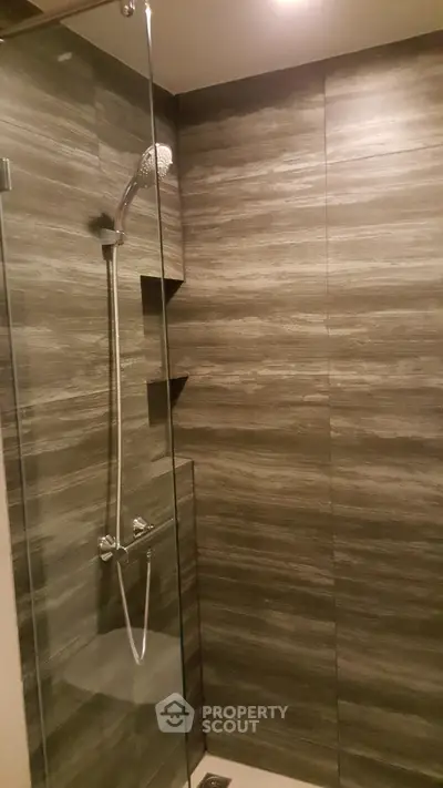 Modern bathroom shower with sleek tile design and glass enclosure