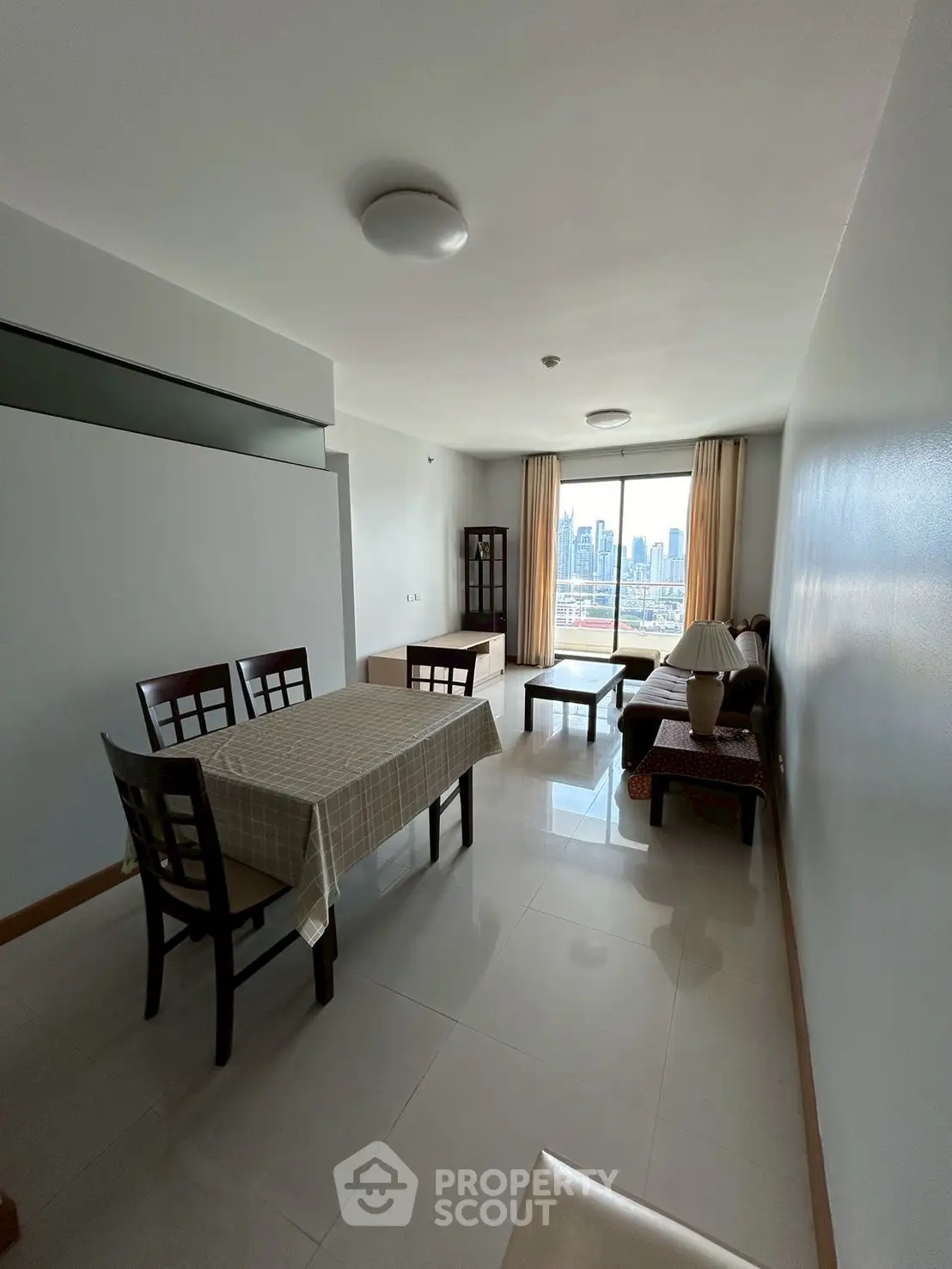 Spacious living room with dining area and city skyline view
