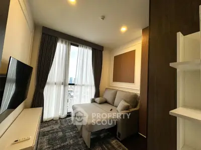 Modern living room with city view, stylish sofa, and large TV