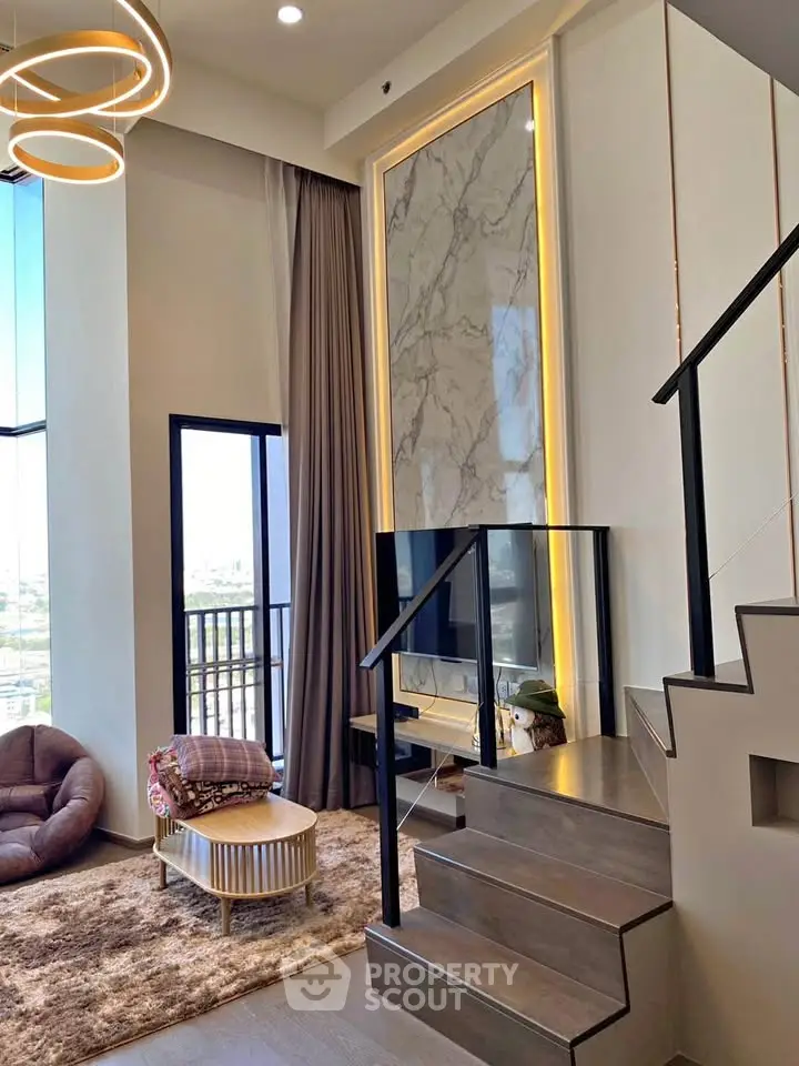Luxurious modern living room with high ceilings and elegant staircase, featuring a stunning city view.