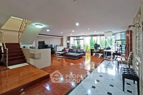 Spacious modern living room with open layout and elegant wooden flooring