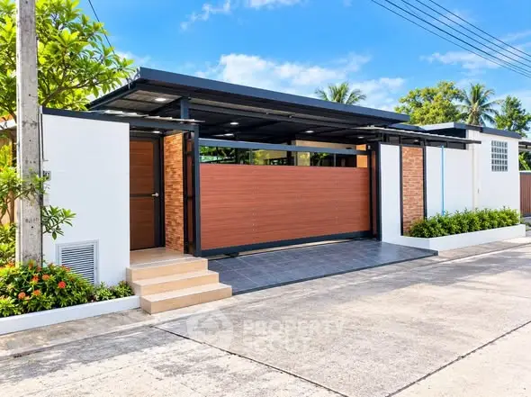 Modern minimalist house exterior with sleek design and lush greenery