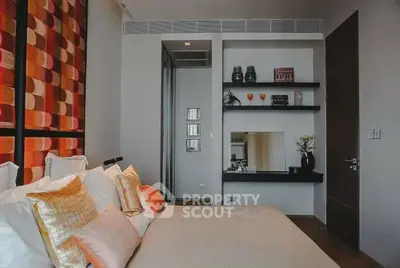 Modern bedroom with stylish decor and cozy ambiance, featuring elegant shelving and contemporary design elements.