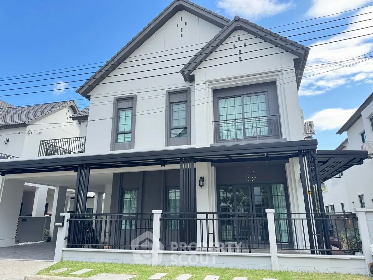 Elegant modern house with stylish facade and spacious balcony in a serene neighborhood.