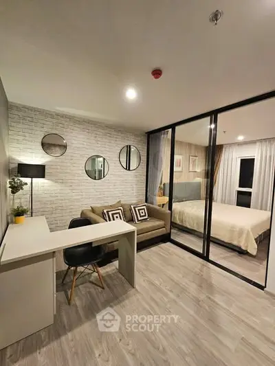Modern studio apartment with stylish decor and glass partitioned bedroom