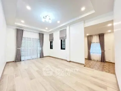 Spacious modern living room with elegant curtains and recessed lighting