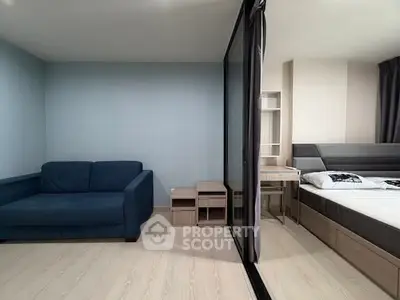 Modern studio apartment with cozy living area and bedroom separation