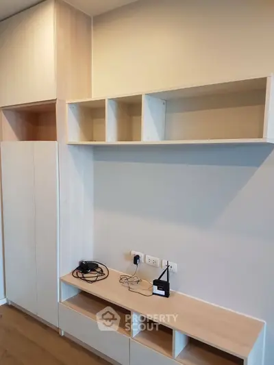 Modern minimalist living room with built-in storage and shelving