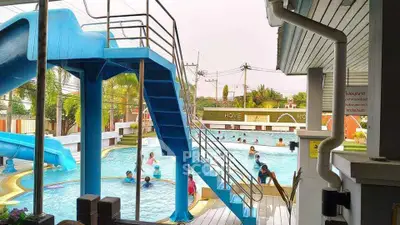 Inviting swimming pool with slide in a vibrant community setting