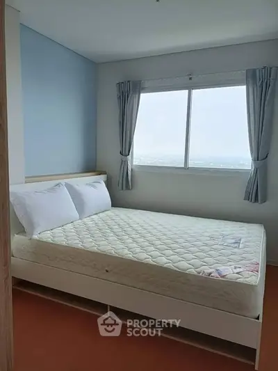 Bright and cozy bedroom with large window and modern decor