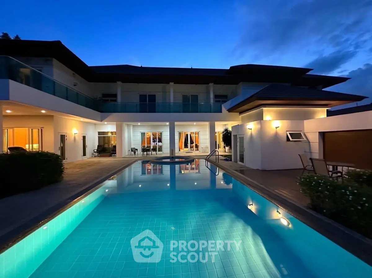 Luxurious modern villa with stunning pool and elegant lighting at twilight.