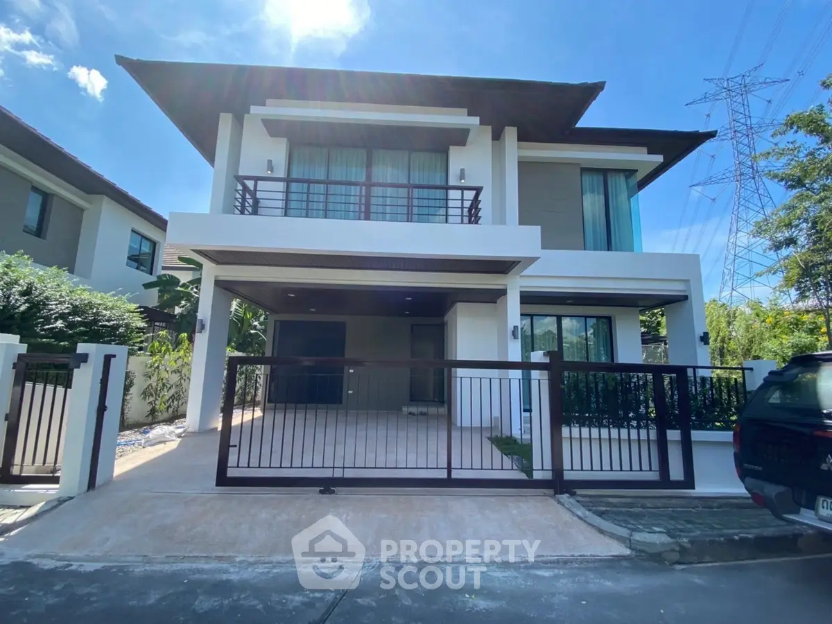 Modern two-story house with spacious driveway and balcony in a serene neighborhood.
