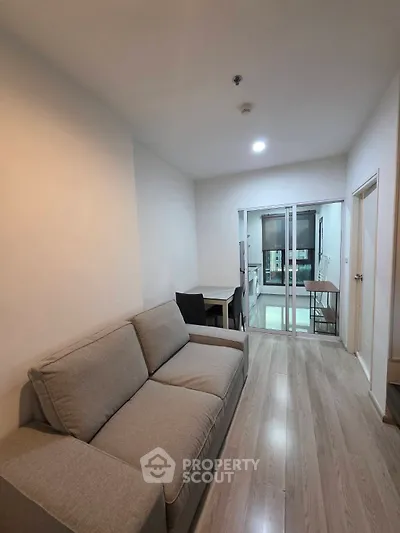 Modern living room with cozy sofa and open kitchen layout