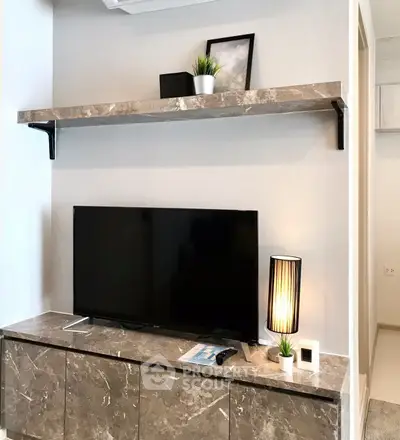 Modern living room with sleek marble TV stand and stylish decor