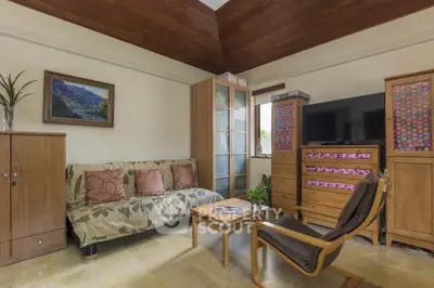 Cozy living room with modern furniture and wooden ceiling accents