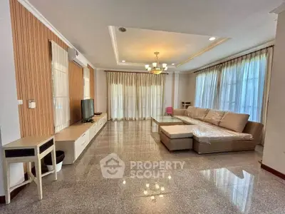 Spacious living room with elegant decor and large windows for natural light.