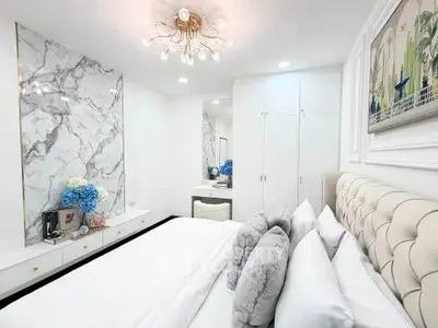 Luxurious bedroom with elegant decor and plush bedding in modern apartment