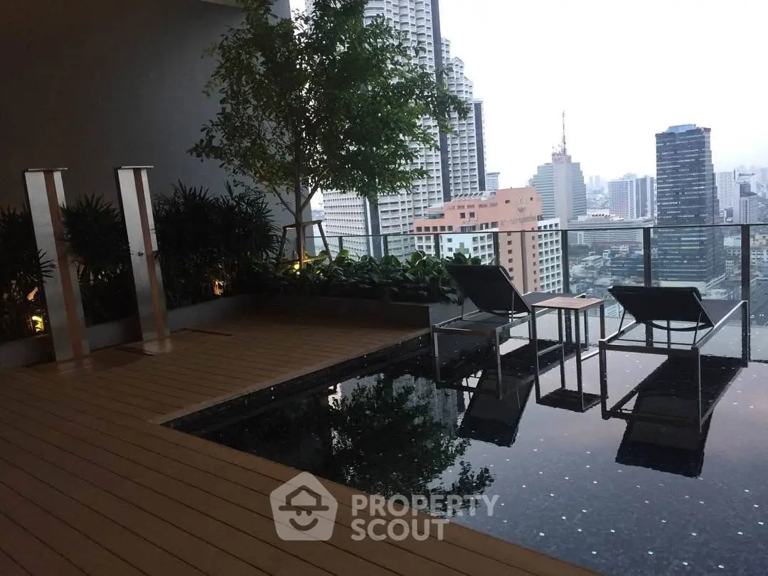Luxurious rooftop pool with stunning city skyline view and modern seating area.