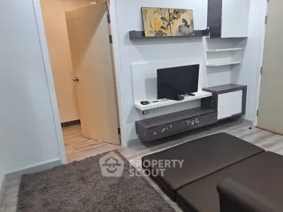 Modern living room with sleek TV unit and cozy seating area