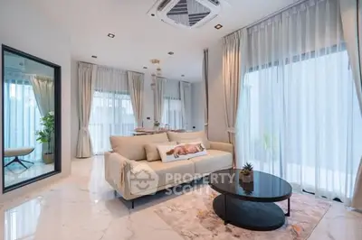 Luxurious modern living room with elegant decor and large windows