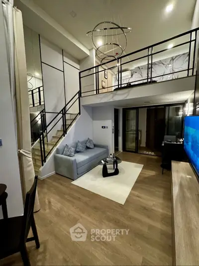 Modern loft-style living room with high ceilings and elegant lighting
