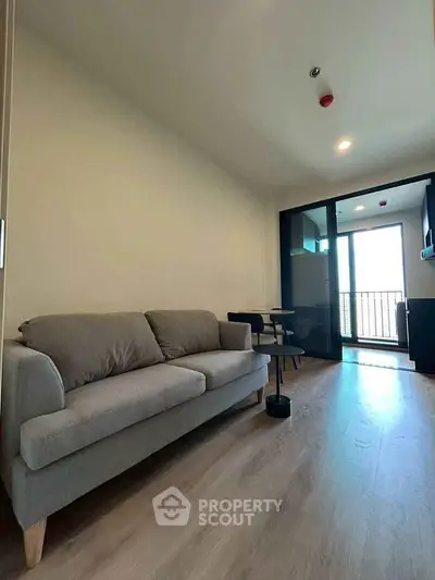 Modern living room with sleek sofa and balcony view