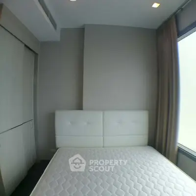 Modern bedroom with sleek design and large window for natural light