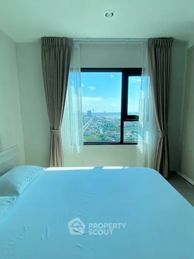 Bright bedroom with large window offering stunning city view, modern curtains, and cozy bed setup.