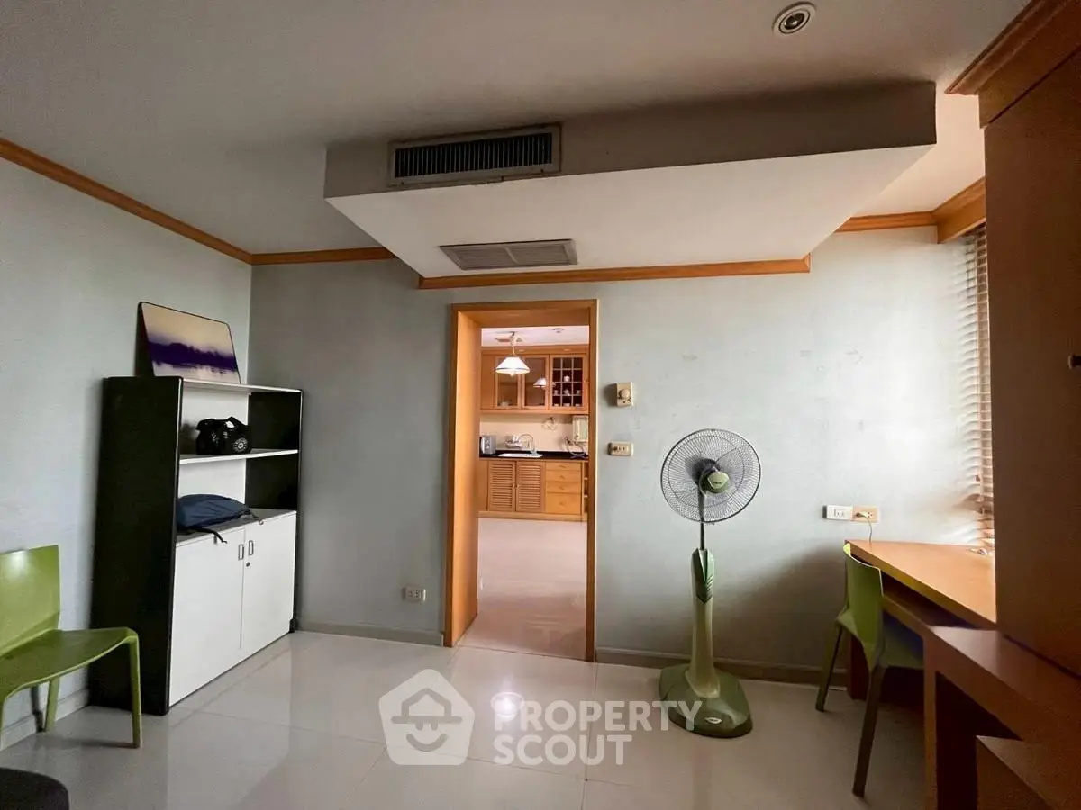 Spacious room with modern decor and open view into kitchen area