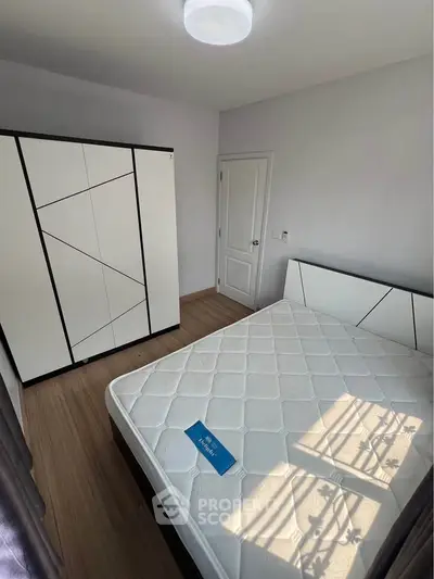 Modern bedroom with stylish wardrobe and comfortable bed in bright natural light.