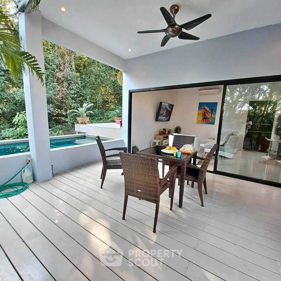 Luxurious outdoor patio with dining set and pool view, perfect for relaxation and entertainment.