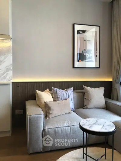 Modern living room with stylish sofa and marble side table, perfect for cozy relaxation.