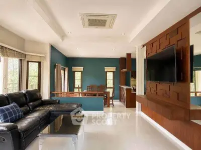 Spacious modern living room with elegant decor and large windows offering natural light.