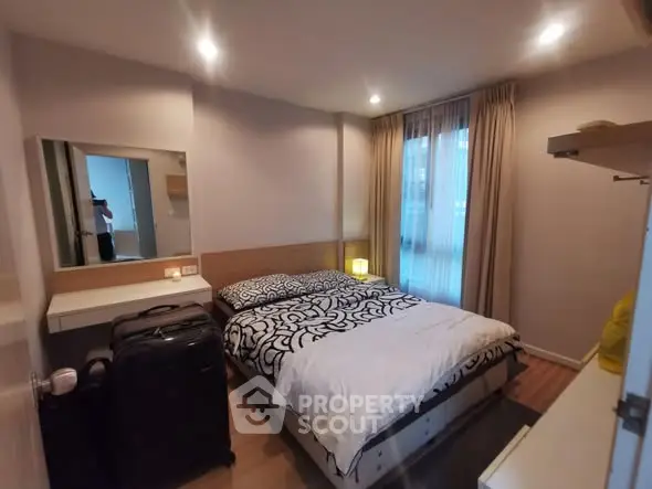 Cozy bedroom with modern decor and ample natural light