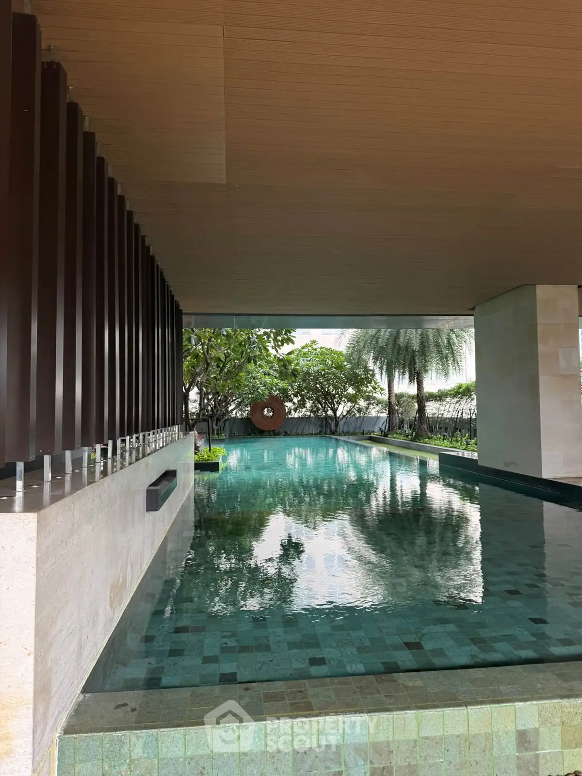 Luxurious modern pool area with serene garden view in upscale property
