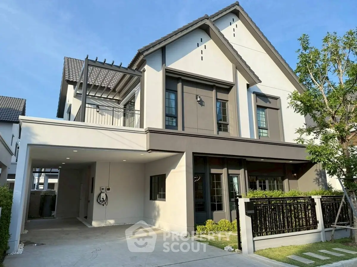 Modern two-story house with spacious driveway and lush greenery