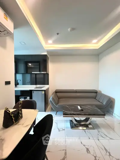 Modern living room with sleek furniture and open kitchen layout