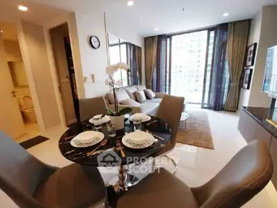 Modern living room with dining area and large windows in a stylish apartment.