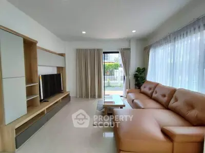 Spacious living room with modern leather sofa and large windows for natural light