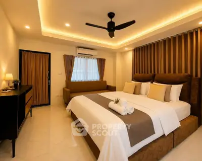 Luxurious bedroom with elegant decor and ambient lighting, featuring a king-sized bed and modern furnishings.