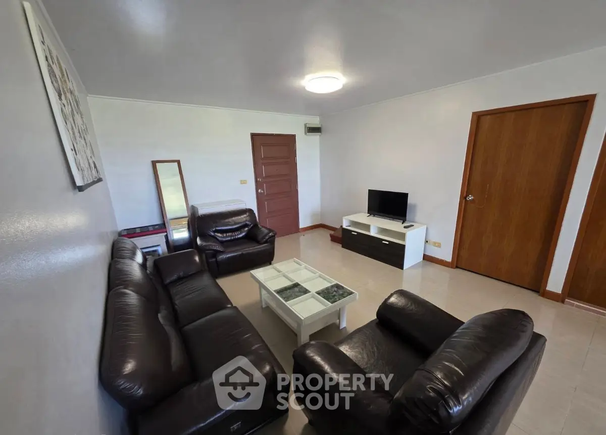 Spacious living room with leather sofas and modern decor