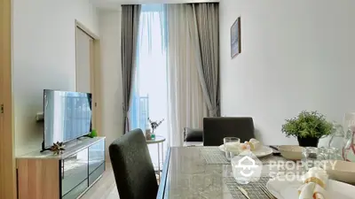 Modern living room with dining area and natural light