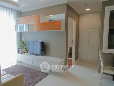 Modern living room with sleek TV unit and natural light