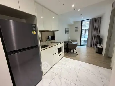 Modern kitchen and dining area with sleek appliances and stylish decor