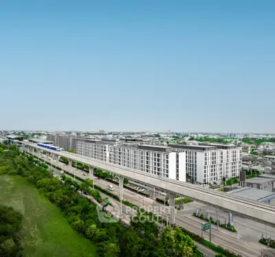 Modern urban apartment complex with convenient transportation access and lush green surroundings.